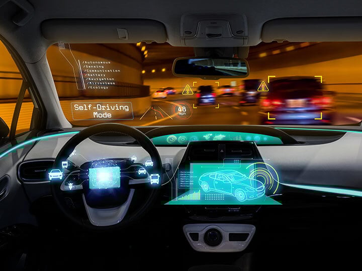 View of dashboard and windshield of the concept of autonomous self driving car going through a tunnel