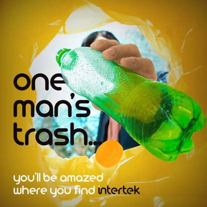 An empty plastic water bottle being dropped into a bag